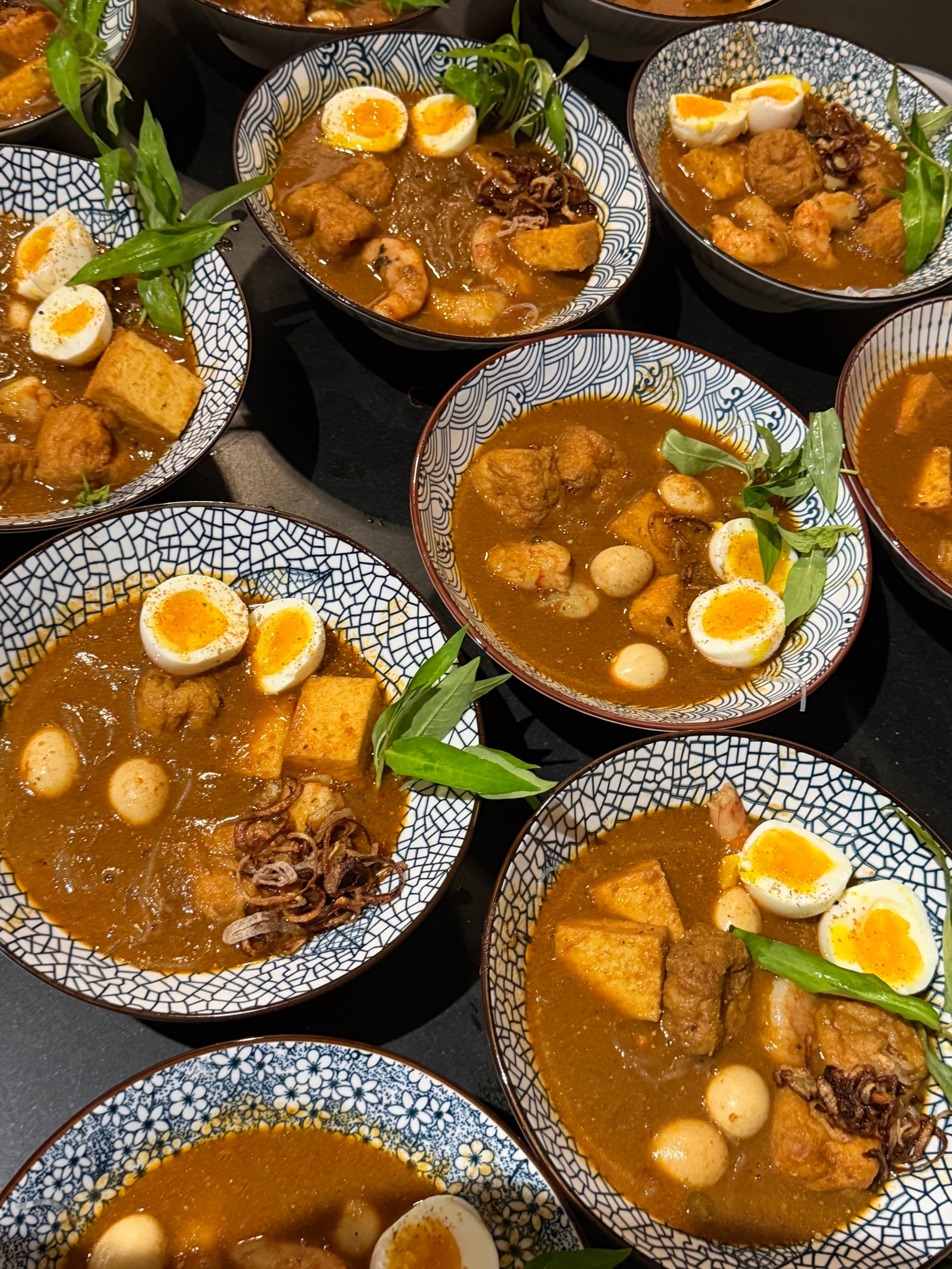 Curry laksa bowls lined up for the second course