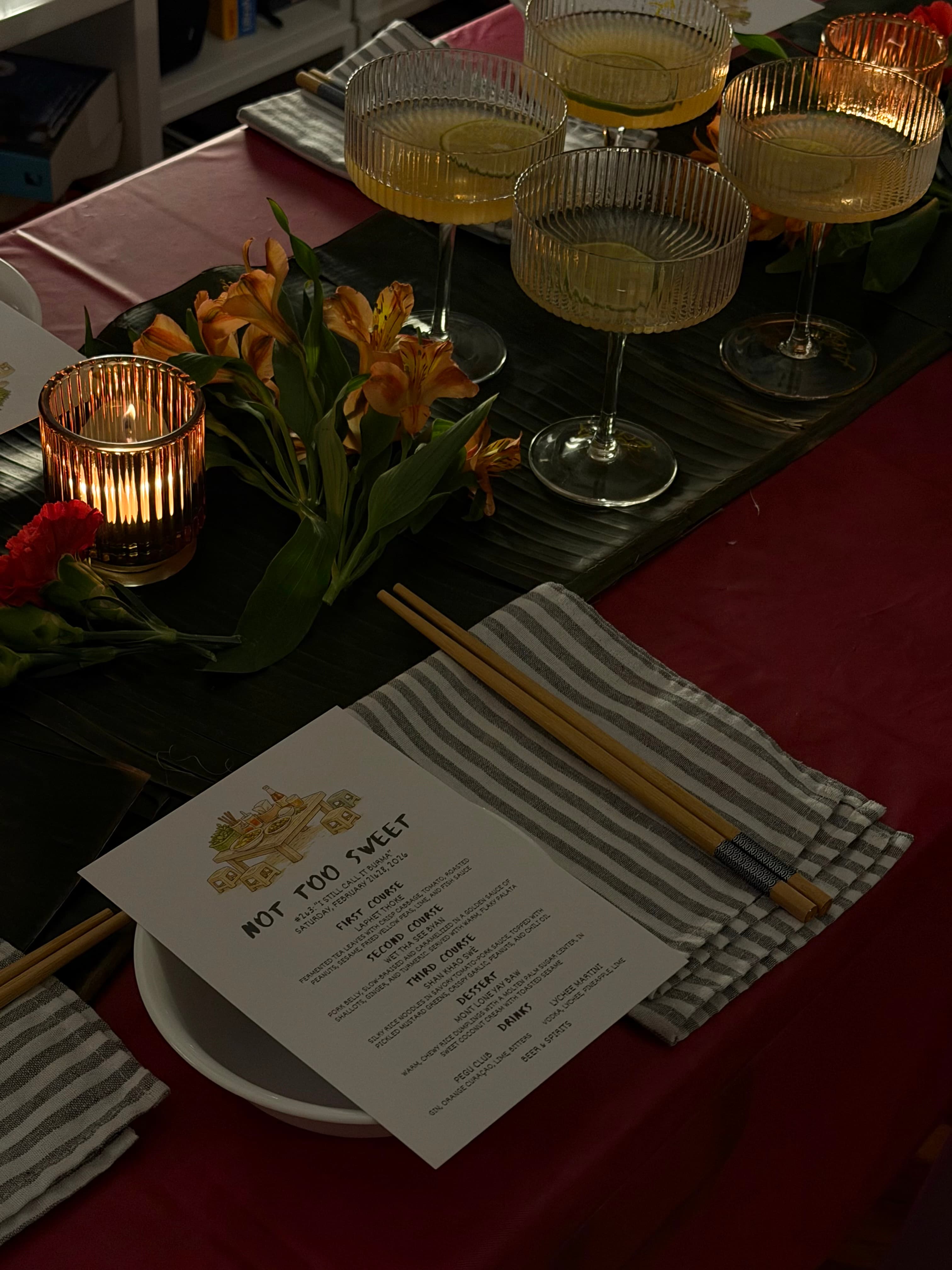 The table before guests arrive, with the printed menu and Pegu Clubs in coupes